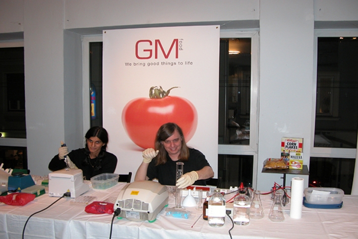 Illustration 9. Free Range Grain demonstration in Graz, Austria with Beatrice de Costa and Critical Art Ensemble’s Steve Kurtz testing store bought food for genetically modified organism markers (2003).