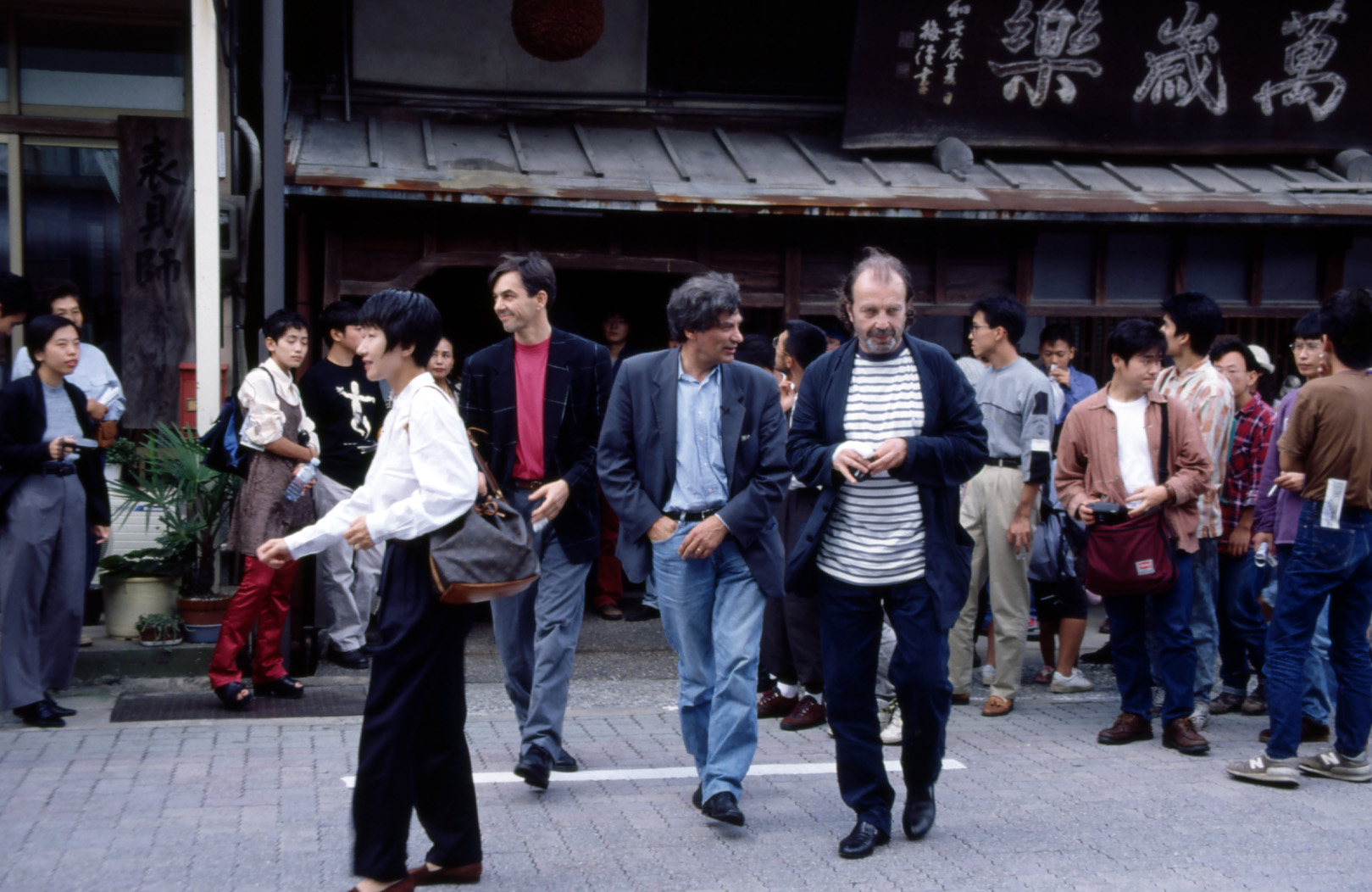 Jan Hoet (center), Franz West (right), and West’s assistant during the walking talk for the exhibition “Jan Hoet in Tsurugi,” in front of the main store of Manzairaku, sake brewery, Hakusan, Ishikawa, September 25, 1994.
