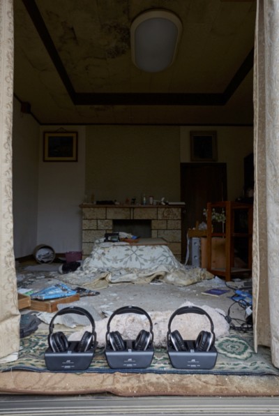 [Image 13. Meirō Koizumi, Home, 2015, collapsing house, audio track, headphones, solar panel. Installation view, Fukushima Prefecture, Japan, courtesy of Don’t Follow the Wind.] 